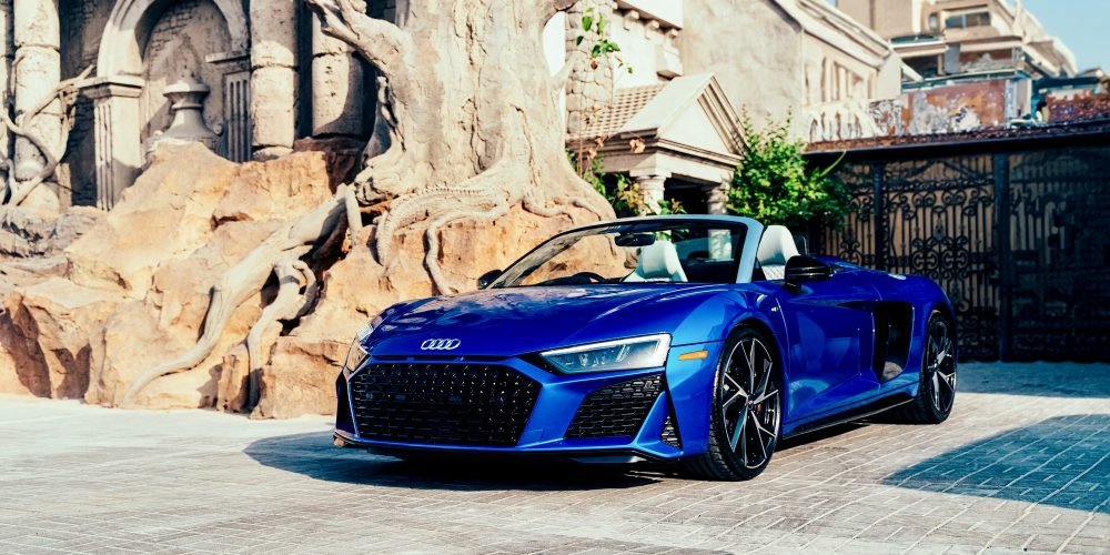 Stunning blue Audi R8 Spyder for rent in Dubai offering a thrilling open-top driving experience with supercar performance luxurious comfort and cutting-edge design
