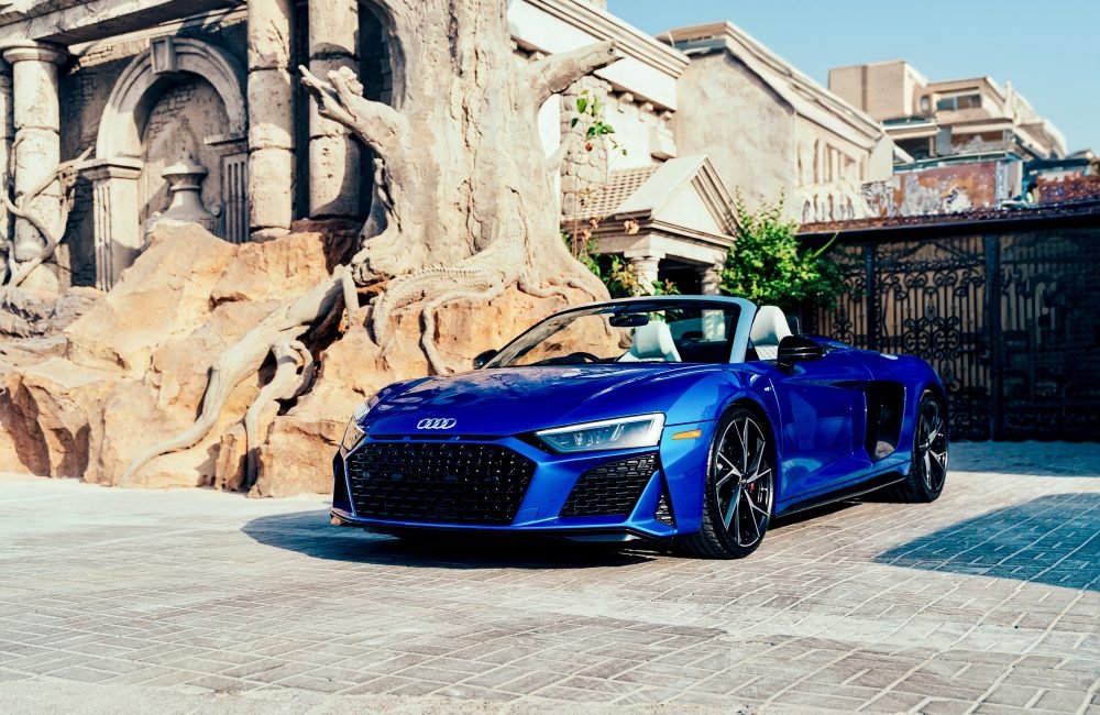 Stunning blue Audi R8 Spyder for rent in Dubai offering a thrilling open-top driving experience with supercar performance luxurious comfort and cutting-edge design