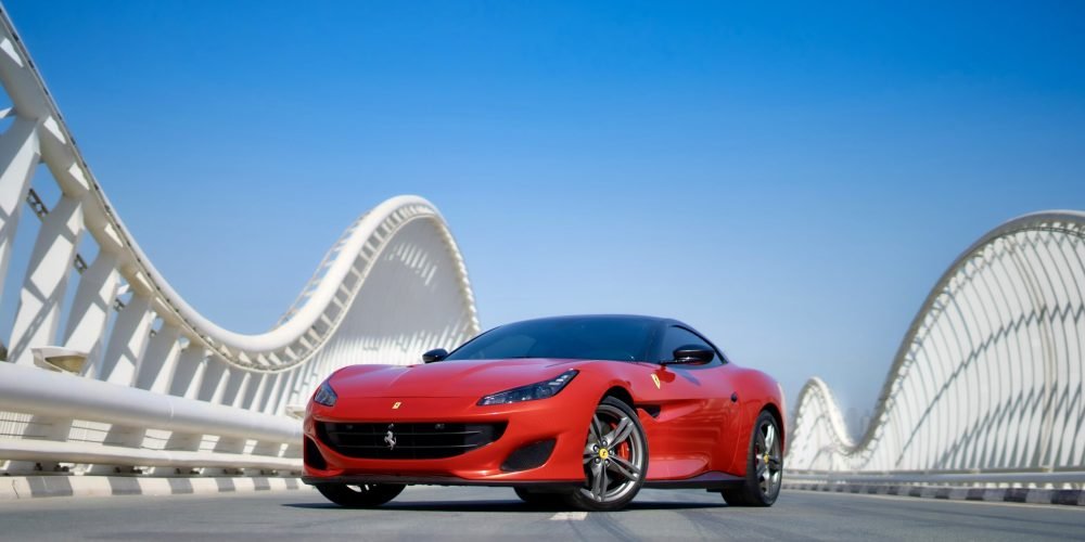 Stunning red Ferrari Portofino 2019 with a black roof for rent in Dubai delivering luxurious design and exhilarating performance