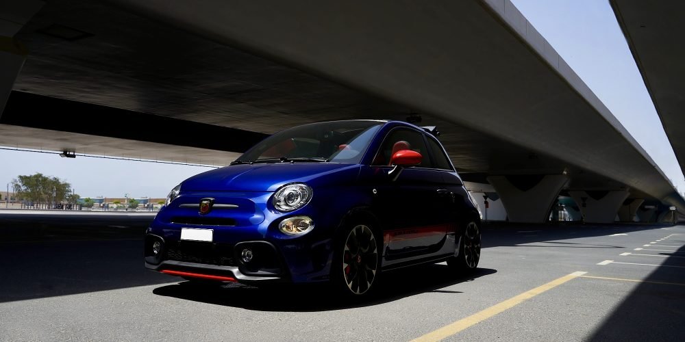 Chic blue Fiat 500 Abarth Cabrio for rent in Dubai offering a fun open-top driving experience sporty performance and stylish compact design for city adventures