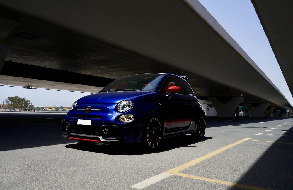 Chic blue Fiat 500 Abarth Cabrio for rent in Dubai offering a fun open-top driving experience sporty performance and stylish compact design for city adventures