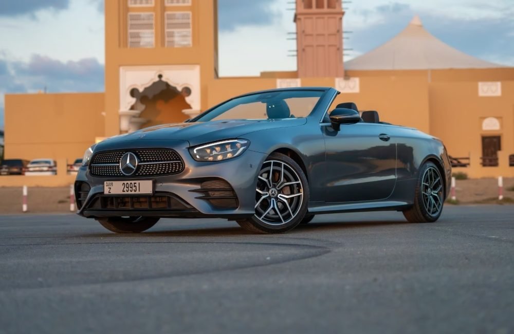 Elegant dark grey Mercedes E200 Cabrio 2022 for rent in Dubai offering a luxurious open-top driving experience with advanced features and smooth performance