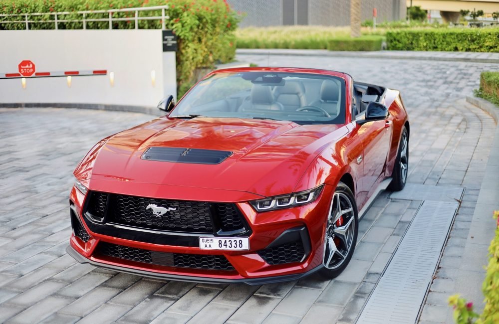 Powerful red Ford Mustang GT Cabrio 2024 for rent in Dubai offering a thrilling open-top driving experience with high-performance engineering sleek design and modern features