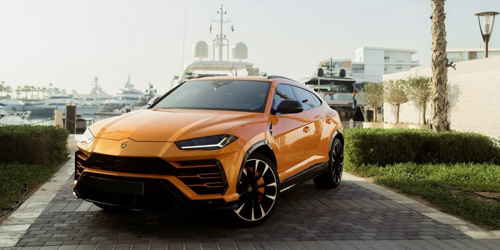 Striking orange Lamborghini Urus for rent in Dubai offering a perfect blend of supercar performance luxury design and advanced technology for an exhilarating driving experience