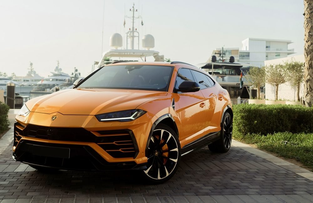 Striking orange Lamborghini Urus for rent in Dubai offering a perfect blend of supercar performance luxury design and advanced technology for an exhilarating driving experience