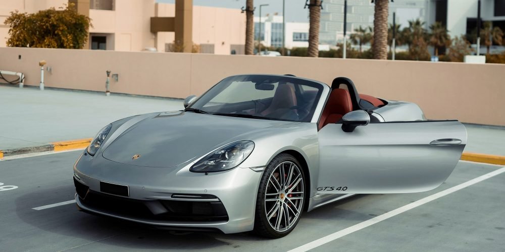 Sophisticated grey Porsche Boxster GTS for rent in Dubai offering a thrilling open-top driving experience with high-performance engineering sleek design and modern technology