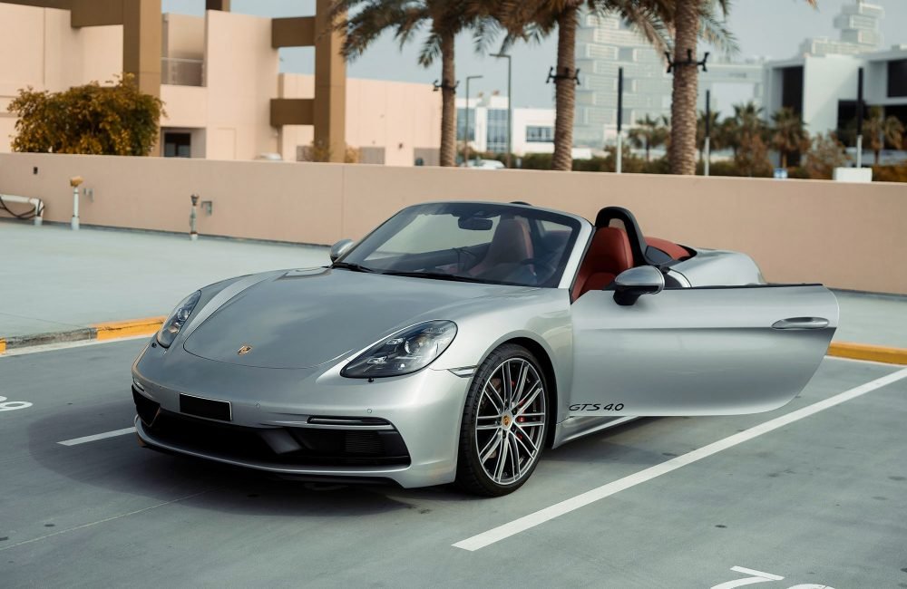 Sophisticated grey Porsche Boxster GTS for rent in Dubai offering a thrilling open-top driving experience with high-performance engineering sleek design and modern technology