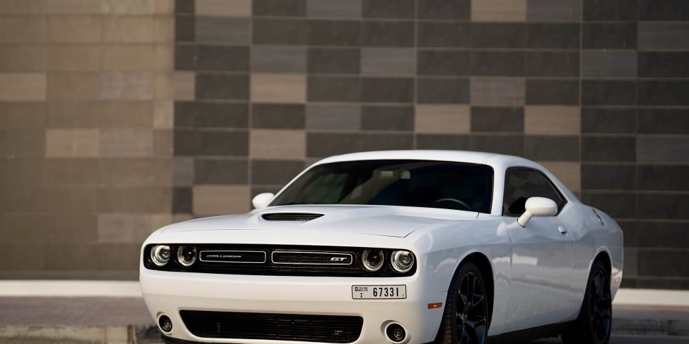Iconic white Dodge Challenger for rent in Dubai offering bold muscle car styling powerful performance and modern features for an exhilarating driving experience