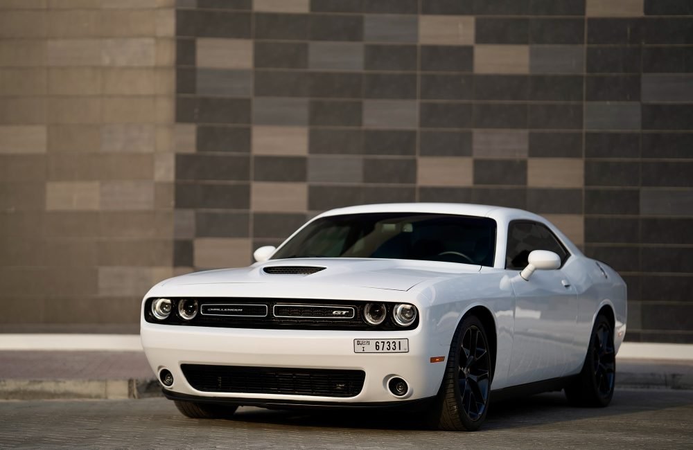 Iconic white Dodge Challenger for rent in Dubai offering bold muscle car styling powerful performance and modern features for an exhilarating driving experience