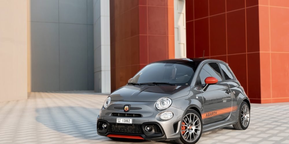 Sporty grey Fiat Abarth 695 Turismo 2023 for rent in Dubai offering compact design high-performance agility and Italian style for a fun and dynamic driving experience