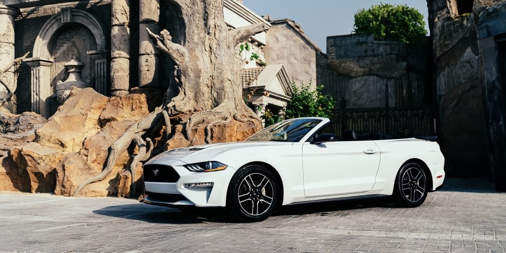 Stylish white Ford Mustang Convertible for rent in Dubai offering a thrilling open-top driving experience with powerful performance modern features and iconic design