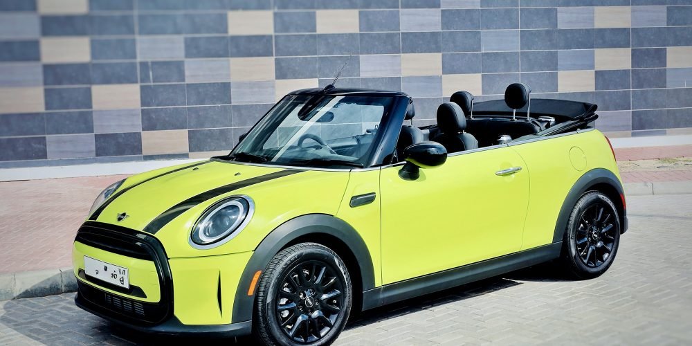 Vibrant yellow Mini Cooper Cabrio 2023 for rent in Dubai offering stylish design open-top driving experience and agile performance for a fun and memorable journey