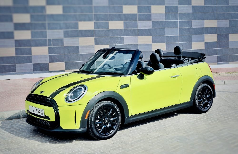 Vibrant yellow Mini Cooper Cabrio 2023 for rent in Dubai offering stylish design open-top driving experience and agile performance for a fun and memorable journey