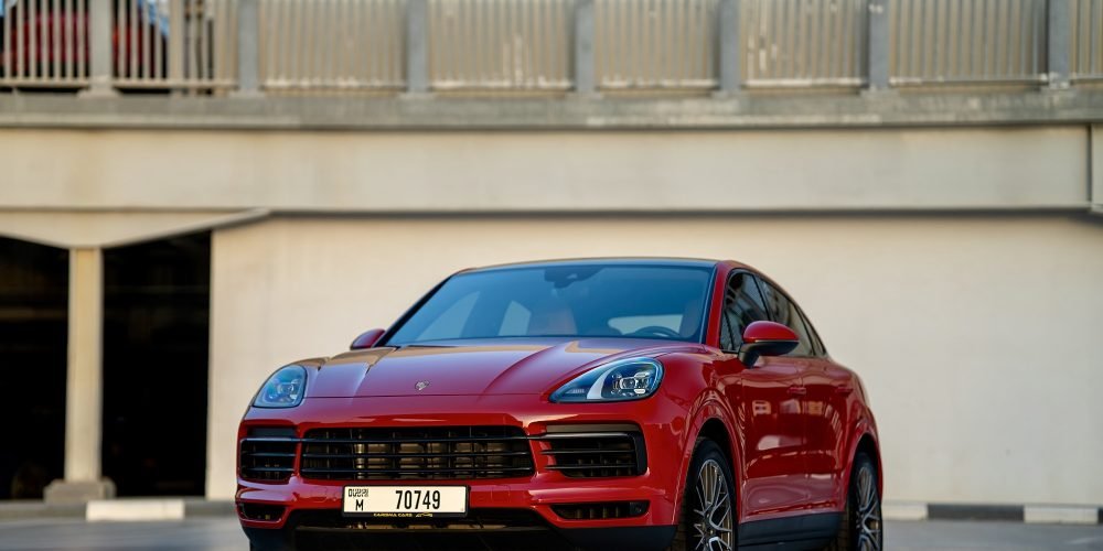 Bold red Porsche Cayenne Coupe for rent in Dubai offering dynamic performance luxurious comfort and advanced technology for an exciting and stylish driving experience