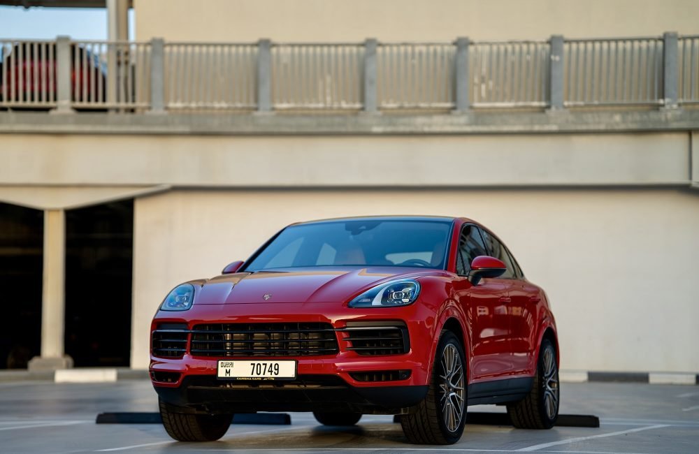 Bold red Porsche Cayenne Coupe for rent in Dubai offering dynamic performance luxurious comfort and advanced technology for an exciting and stylish driving experience